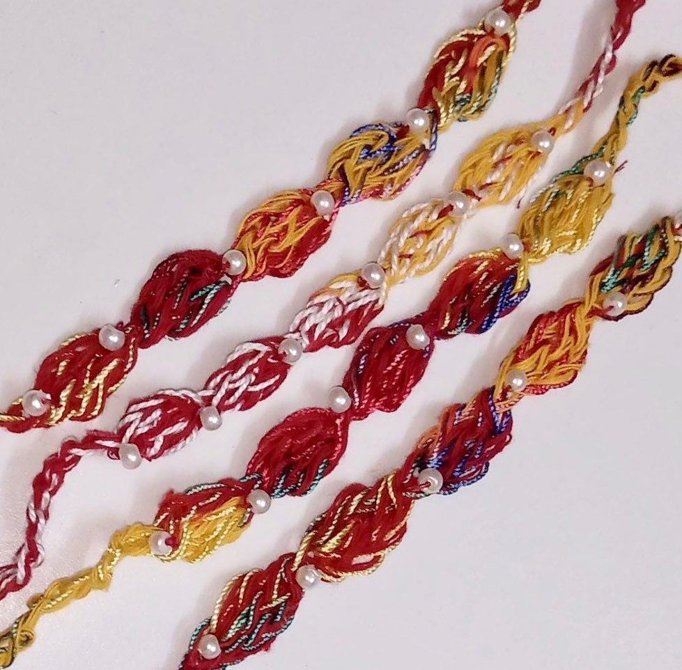 All these pretty Doris for rakhi are made with mauli and beads